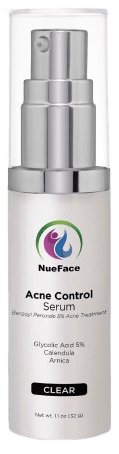 A bottle of NueFace Acne Control Serum with a pump dispenser. The label mentions ingredients like glycolic acid 5%, calendula, and arnica. The solution is labeled "clear.