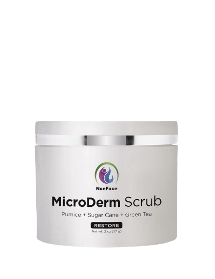 A jar of MicroDerm Scrub by NueFace, listing ingredients: pumice, sugar cane, and green tea. The label includes the word "Restore.